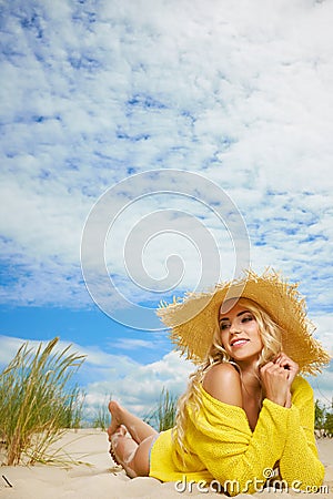 Blonde wearing sun hat at the beach Stock Photo