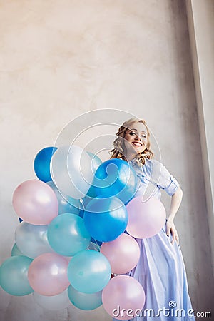 Blonde woman with balloons celebrates something Stock Photo