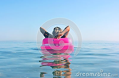 Blonde woman with inflatable raft Stock Photo