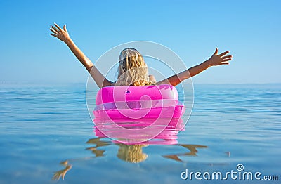 Blonde woman with inflatable raft Stock Photo