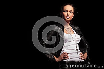 Blonde woman in leather clothes standing with hands on wais Stock Photo