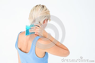 Blonde woman putting gel pack on neck Stock Photo