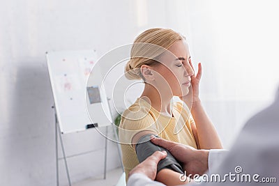 blonde woman suffering from headache while Stock Photo