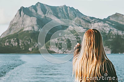 Blonde Woman traveling by ferry enjoying Norway mountains and sea landscape Travel Lifestyle concept adventure vacations Stock Photo