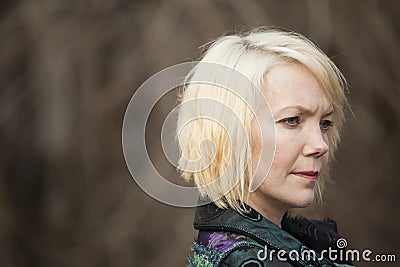 Blonde Woman in Very Colorful Winter Coat Stock Photo