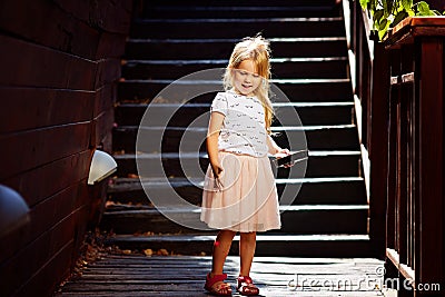 Blonde on a wooden staircase enjoying summer vacation Stock Photo
