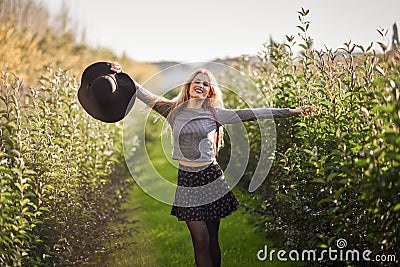 Blonde young woman happy in rural road Stock Photo