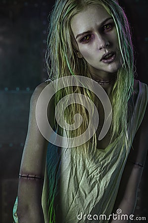 Blonde zombie woman on dark background Stock Photo