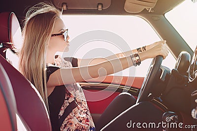 Blondie young girl at the wheel of sport car Stock Photo