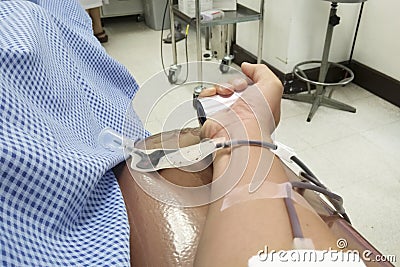 Blood donor at donation with a bouncy ball holding in hand Stock Photo