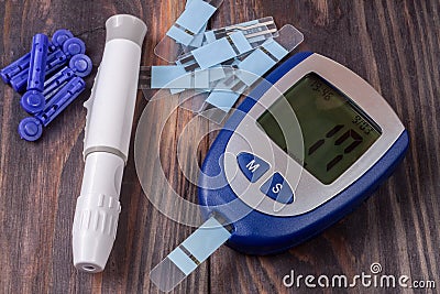 Blood glucose meter on a black wooden background Stock Photo