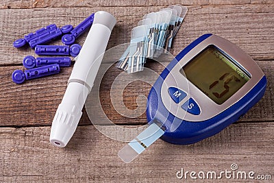 Blood glucose meter on an old wooden background Stock Photo