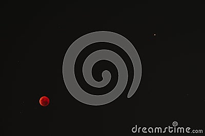 Blood moon and Mars during total lunar eclipse, as viewed from Marginal de Luanda, Angola Stock Photo