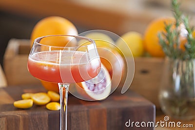 Blood orange alcohol beverage with ingredients in background Stock Photo