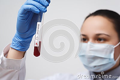 Blood test tube in doctor hand, Mers-CoV Coronavirus test Positive label in hospital blood test tube for analysis. 2019-nCoV virus Stock Photo