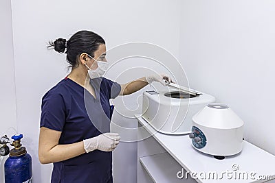 The blood tube is removed from the medical centrifuge for plasma lifting. Prp procedure. Cosmetology and skin care. Platelet-Rich Stock Photo
