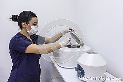 The blood tube is removed from the medical centrifuge for plasma lifting. Prp procedure. Cosmetology and skin care. Platelet-Rich Stock Photo