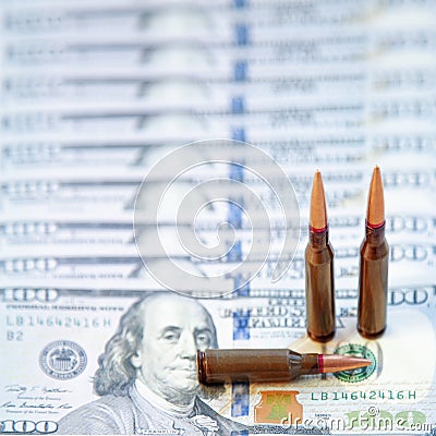 The bloody business of war. Bullets on dollar bills as symbol of Stock Photo