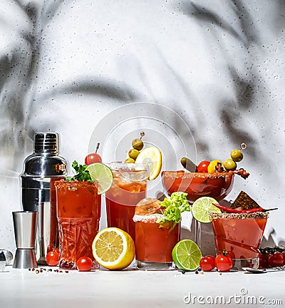 Bloody Mary, Joseph, Caesar and other red cocktails set with tomato juice, vodka, hot sauce and celery. Cocktail party. Gray Stock Photo