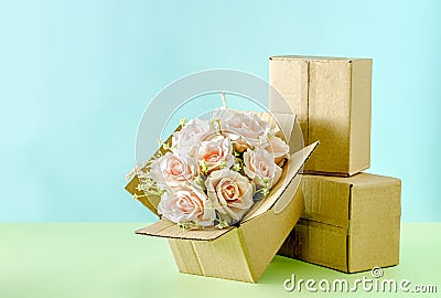 Blooming bouquet of pink roses in a cardboard box Stock Photo