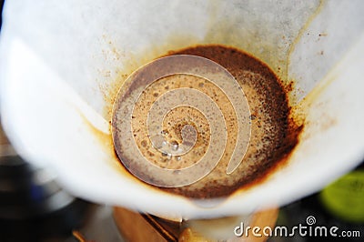 Blooming coffee in paper filter close up. Manual drip brewing Stock Photo