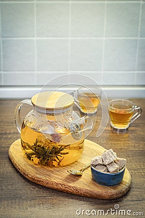 Blooming flowering tea in glass teapot Stock Photo