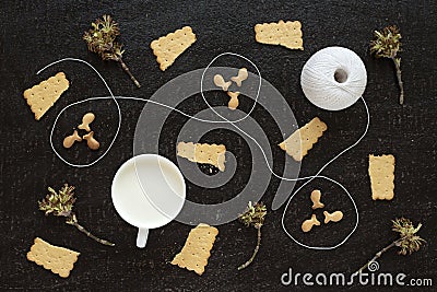 Blossoming twigs, milk, cotton skein and cookies Stock Photo