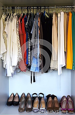 Clothes and shoes in the wardrobe Stock Photo