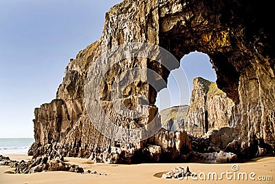 Blow hole forming a rock archway beneath the Pembroke Coastline between Lydstep and Manorbier Bay Stock Photo