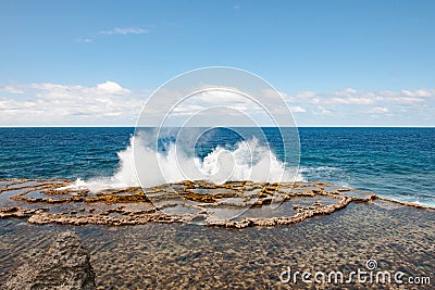 Blow Holes in Tonga, water splashing out rocks on shore of South Pacific Ocean Stock Photo