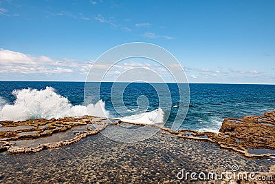 Blow Holes in Tonga, water spouting out rocks on shore of South Pacific Ocean Stock Photo