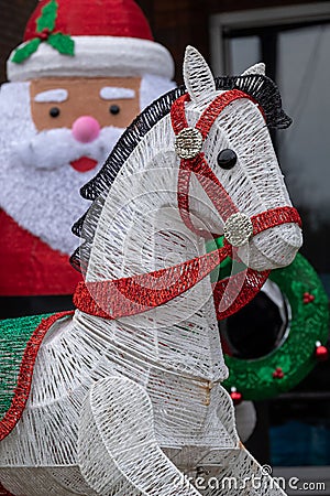 Inflatable Father Christmas with reindeer in foreground, photographed in a suburban garden in Windsor, Surrey UK. Stock Photo