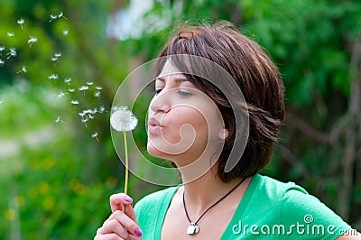 Blowing a dandelion Stock Photo