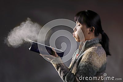 Blowing dust off a book. Stock Photo