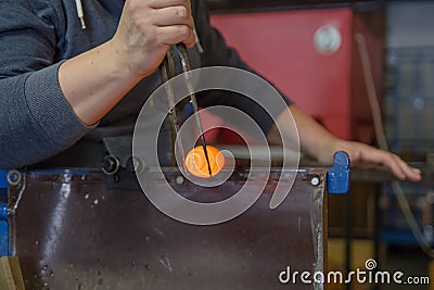 Blowing glass souvenir in glasswork in czechia, human hands make glass produst Stock Photo