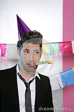 Blowing noisemaker suit party funny young man Stock Photo