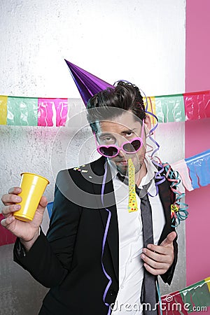 Blowing noisemaker suit party funny young man Stock Photo