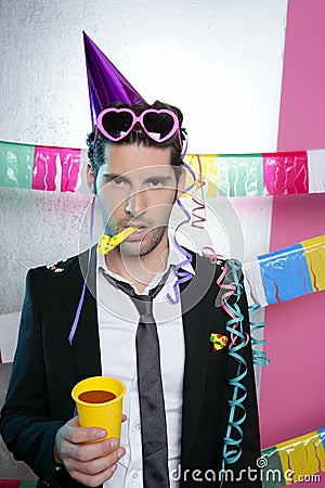 Blowing noisemaker suit party funny young man Stock Photo