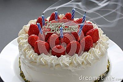 Blowing out candles on the birthday cake Stock Photo