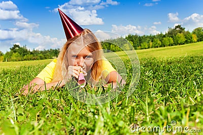 Blowing in party noisemaker whistle Stock Photo