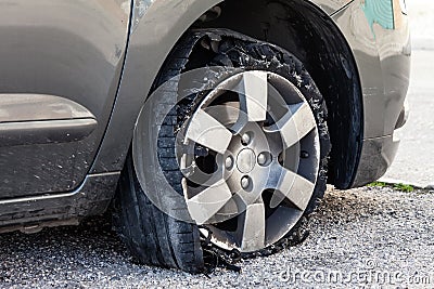 Blown out tire with exploded, shredded and damaged rubber Stock Photo