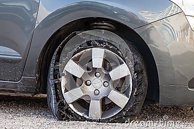 Blown out tire with exploded, shredded and damaged rubber Stock Photo