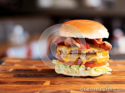 BLT cheeseburger on wooden table Stock Photo