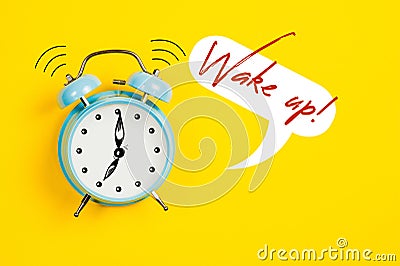 Blue alarm clock with graphics and text Wake up Stock Photo