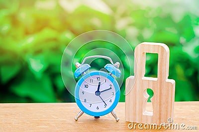 Blue alarm clock and padlock. The concept of an alarm or a temporary ban, freezing. Non-durable protection time-tested protection Stock Photo