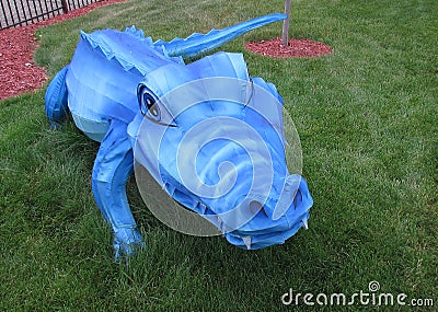 Blue Alligator made from Fabric on Green Grass Stock Photo