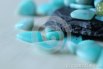 Blue amazonite stones lie in loose on black plato Stock Photo