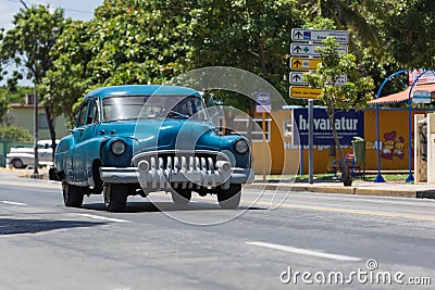 Blue american classic car drive on the road trough VaraderoCuba Editorial Stock Photo