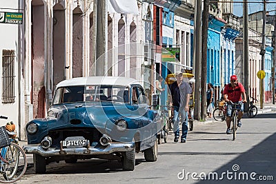 Blue american vintage car in the province Villa Clara with street life view Editorial Stock Photo