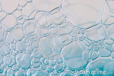 Blue aquamarine color foam bubbles from liquid soap macro wallpaper or background Stock Photo